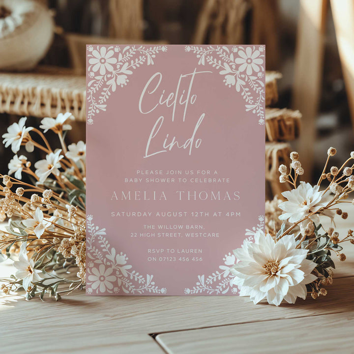 Customizable pink Cielito Lindo invitation for a baby shower honoring Amelia Thomas, with RSVP details included.
