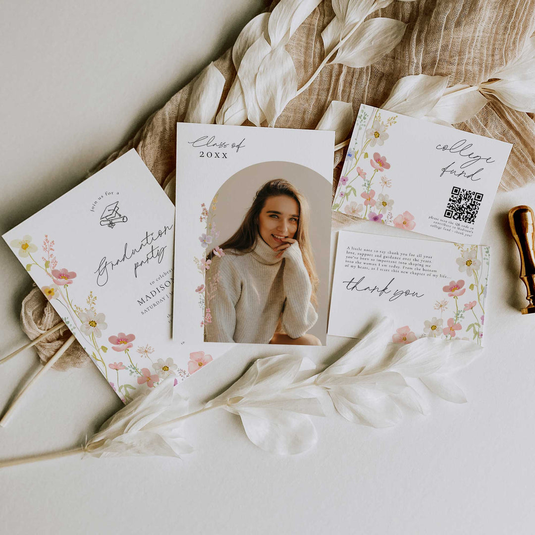 Graduation invitations with floral designs and a photo of a woman on a textured surface.