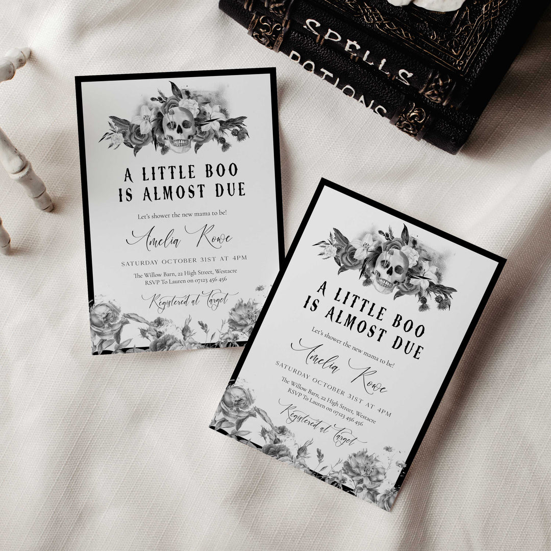 Vintage-style baby shower invitation featuring skull surrounded by roses and lilies for a spooky yet elegant theme.