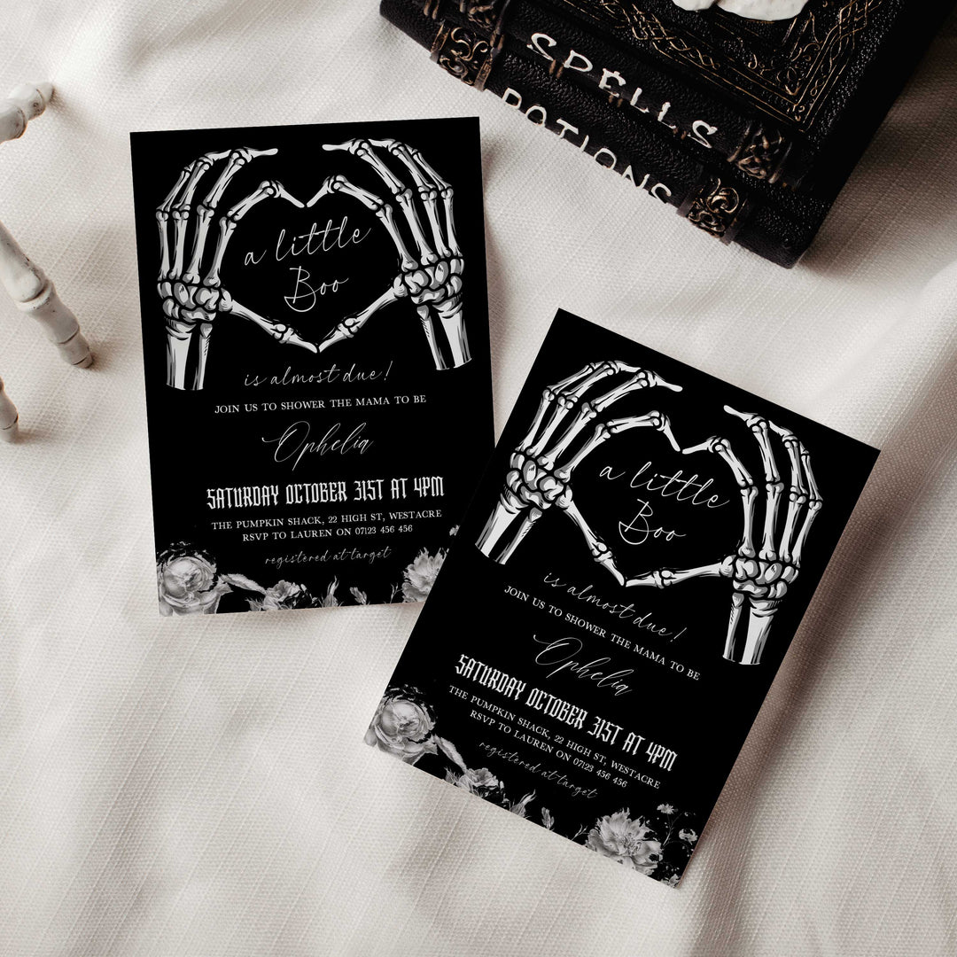 Spooky Halloween baby shower card featuring skeleton hands, gothic fonts, and elegant floral details for mom-to-be