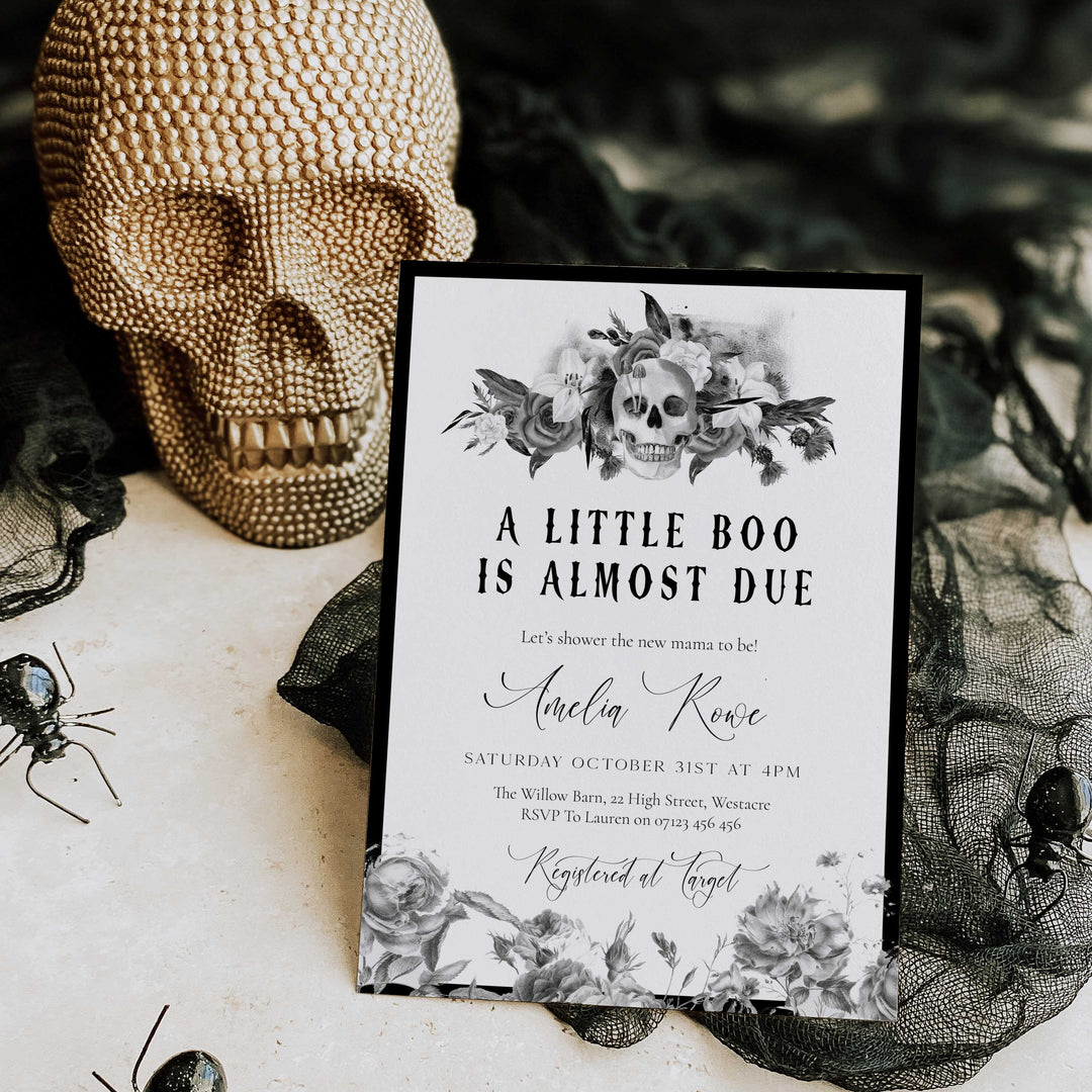 Halloween baby shower invitation with floral skull design and ‘A Little Boo Is Almost Due’ text for spooky celebration.