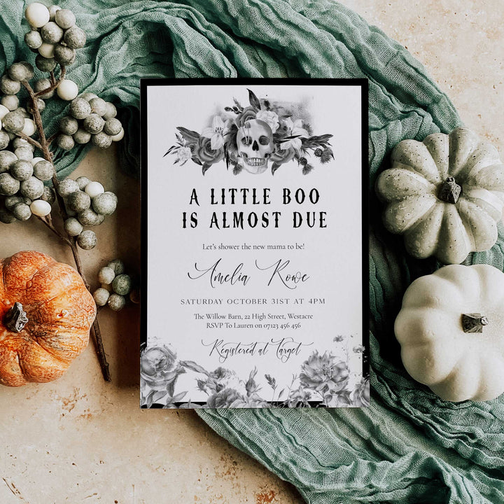 Floral skull Halloween baby shower card with bold gothic title and October 31st event details.