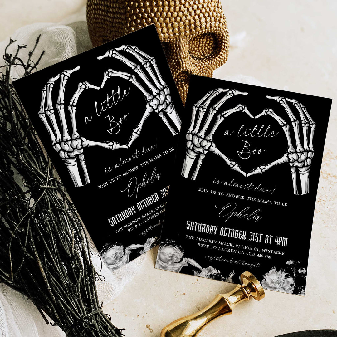 Gothic-themed baby shower invitation with skeleton heart hands and floral border, ideal for fall gatherings.