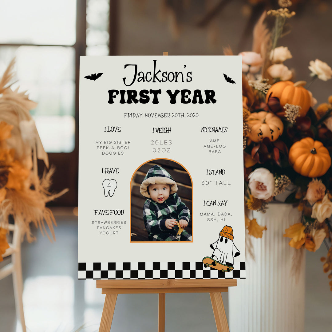 Halloween birthday milestone board with spooky ghost and skateboard graphic, personalized with baby’s name and photo for first birthday party.