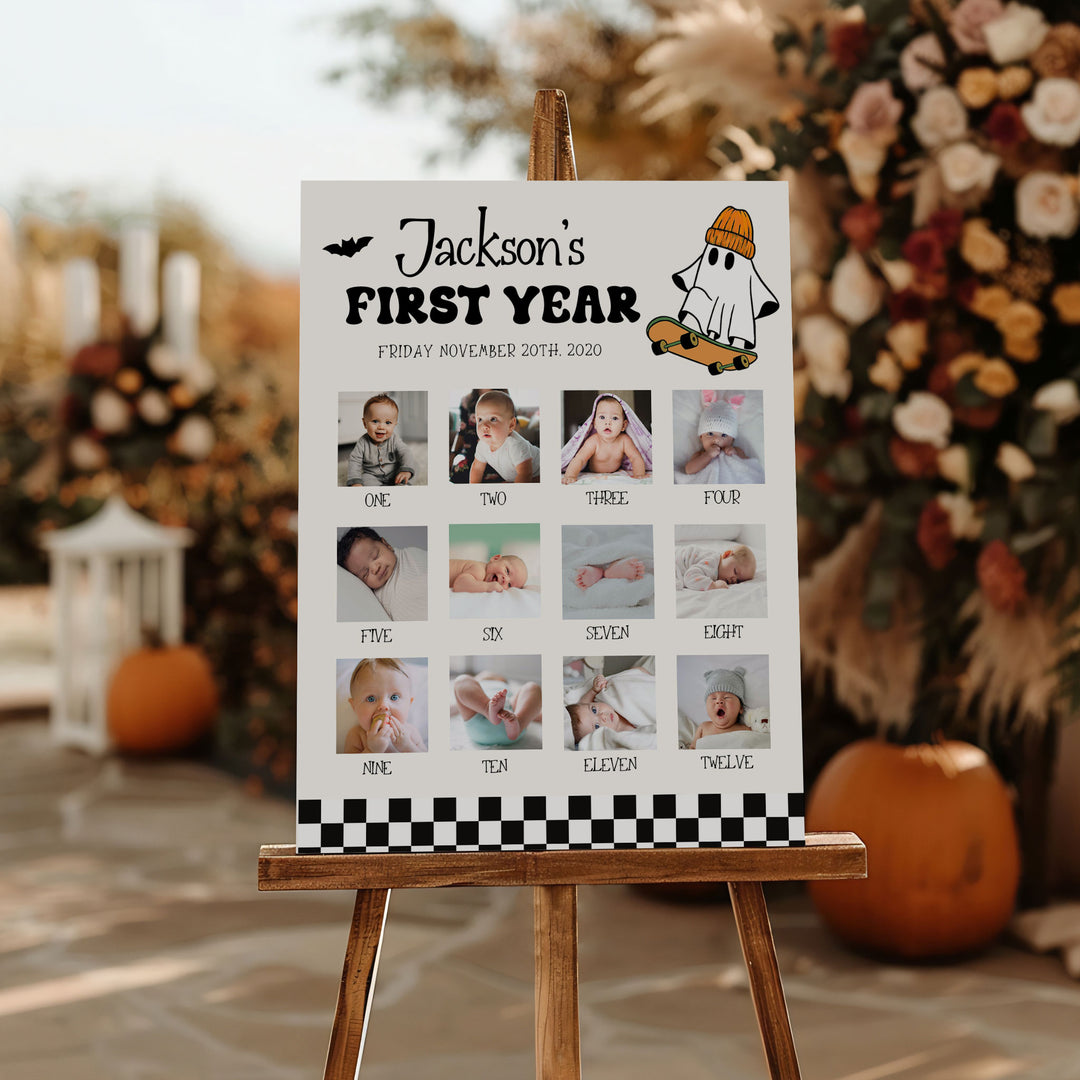 Personalized “First Year” milestone sign for baby Jackson with spooky ghost illustration and checkerboard border for first birthday party.