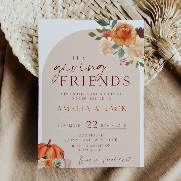 Warm and inviting Friendsgiving card with floral artwork and pumpkin graphics, ideal for sharing holiday dinner details.