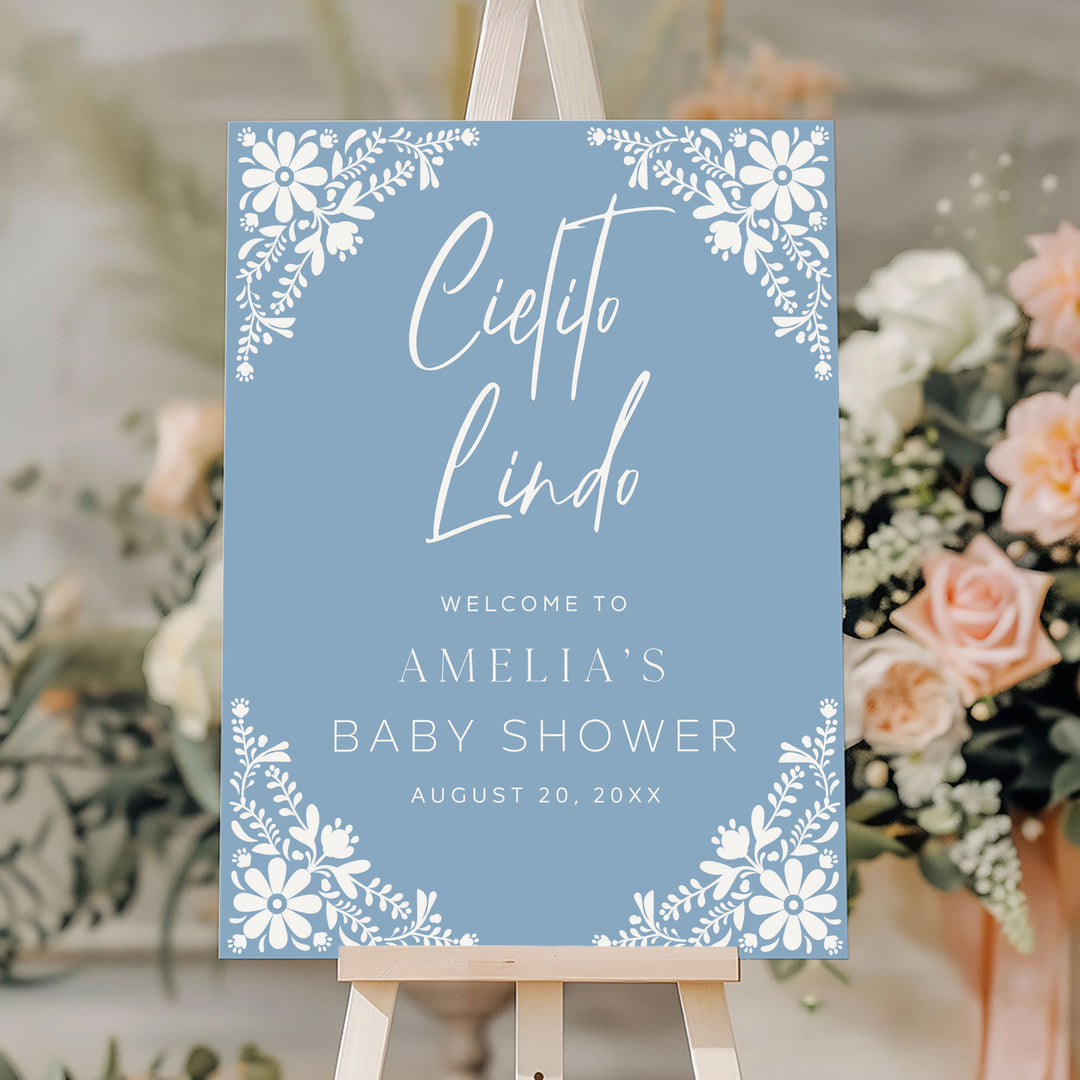 Blue Cielito Lindo baby shower welcome sign with white folk floral design, perfect for fiesta-themed celebrations.