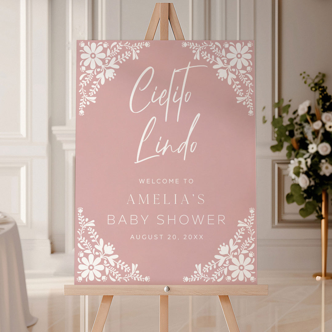 Personalized baby shower sign in dusty rose pink with elegant Cielito Lindo calligraphy and folk-inspired flower accents.