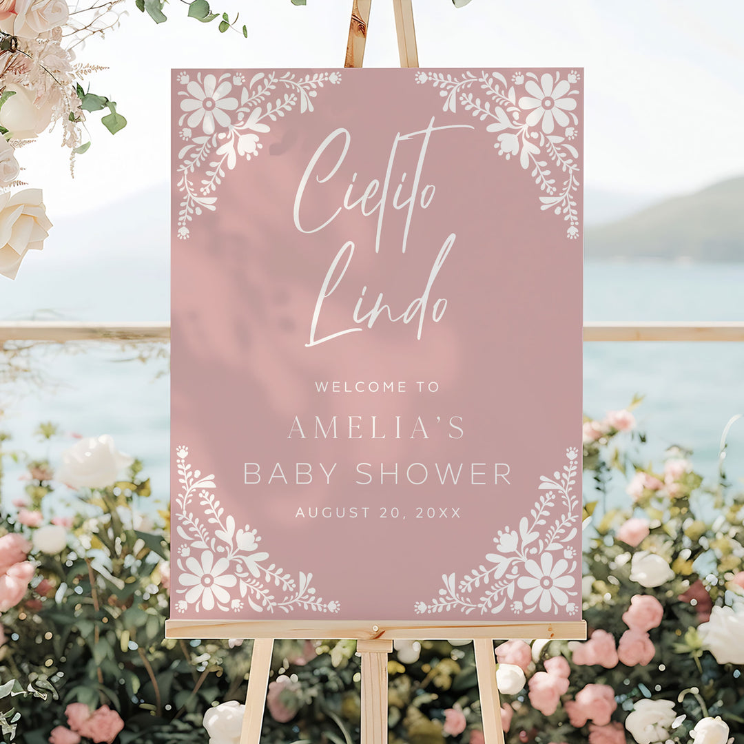Cielito Lindo welcome sign in rose pink with white text and Mexican folk art flowers, styled for an elegant garden event.