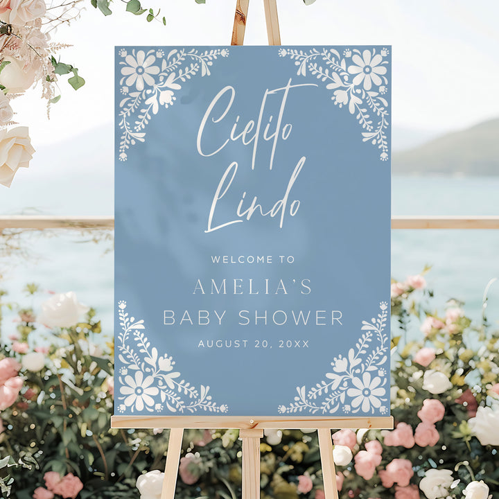 Cielito Lindo themed welcome board for baby shower, set up near patio seating with floral accents and neutral tones.