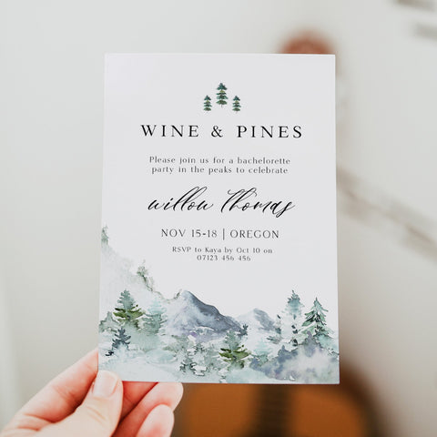 Fully editable and printable wine and pines invitation with a mountain design. Perfect for a snowy cabin mountain bridal shower