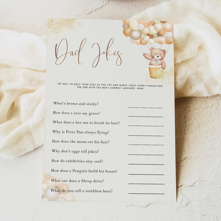 Fully editable and printable baby shower dad jokes game with a hot air balloon teddy bear, we can bearly wait design. Perfect for a We Can Bearly Wait baby shower themed party