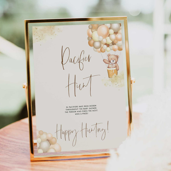 Fully editable and printable baby shower pacifier hunt game with a hot air balloon teddy bear, we can bearly wait design. Perfect for a We Can Bearly Wait baby shower themed party