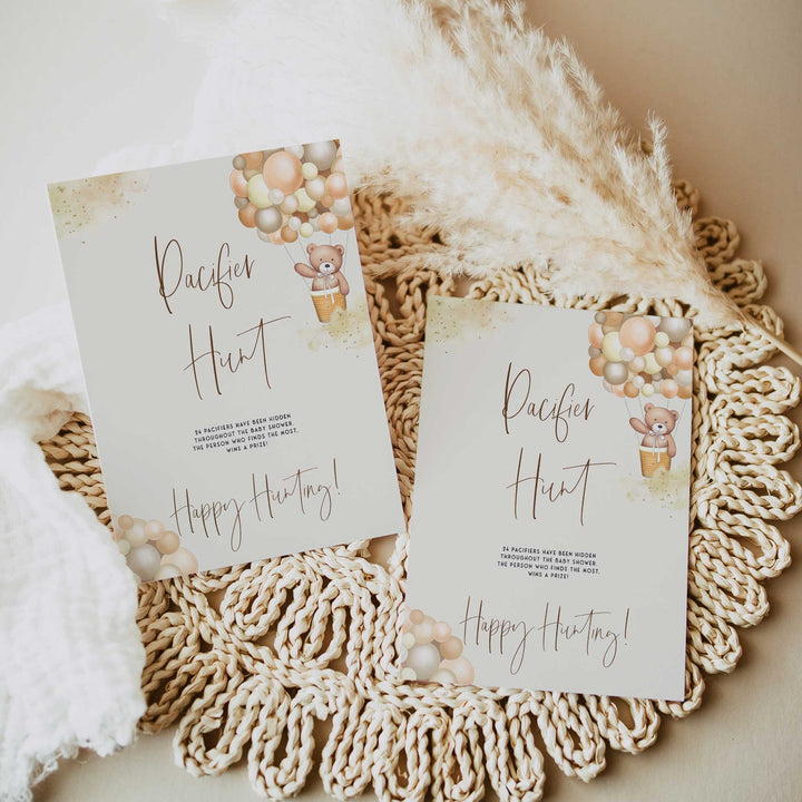 Fully editable and printable baby shower pacifier hunt game with a hot air balloon teddy bear, we can bearly wait design. Perfect for a We Can Bearly Wait baby shower themed party